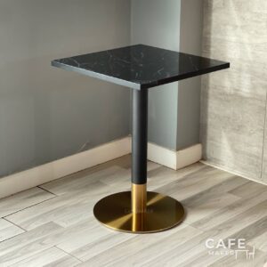 Isometric view of a black marble table featuring stylish black and gold leg, highlighting its contemporary design