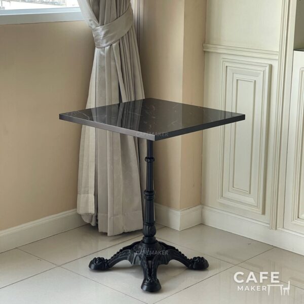 Isometric view of a black marble table featuring ornate Roman leg, showcasing its elegant design
