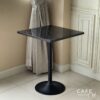 Isometric view of a black marble table featuring elegant leg, highlighting its modern design