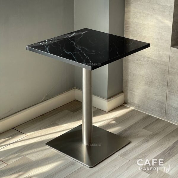 Isometric view of a black marble table featuring sturdy metal leg, highlighting its modern design
