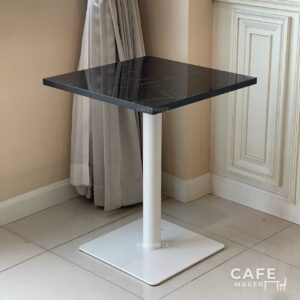 Isometric view of a black marble table featuring sleek white leg, showcasing a modern design