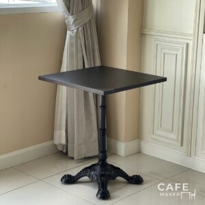 Isometric view of a black top table with Roman-style legs
