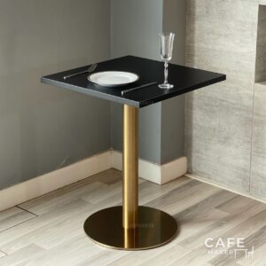 Black top table with golden legs styled as a dining prop