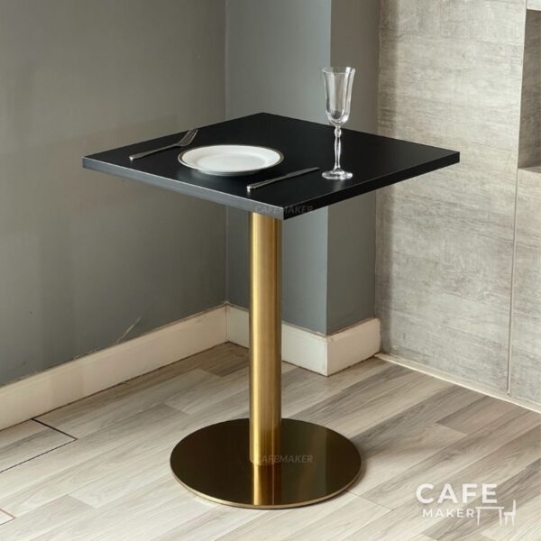 Black top table with golden legs styled as a dining prop