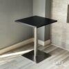 Isometric view of a black top table with square metal leg