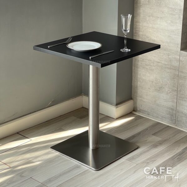 Black top table with square metal leg styled as a dining set