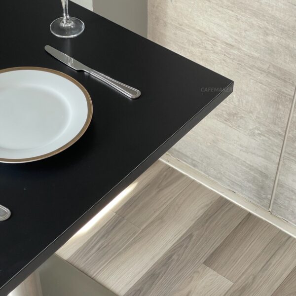 Top view of black top table with metal leg