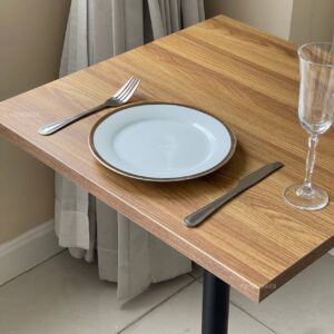 Top view of an oak top table featuring round leg, showcasing its natural grain and design