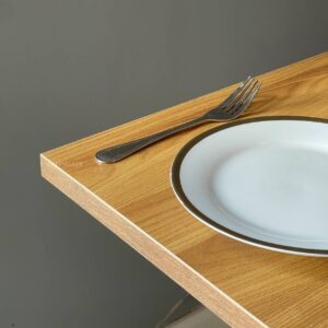 Close-up view of an oak top table showcasing its smooth surface and sturdy metal leg