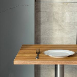 Top side view of an oak top table featuring metal leg, highlighting its elegant design and craftsmanship