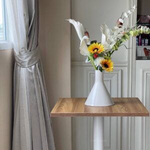 Oak top table with square white leg, beautifully adorned with a flower arrangement on top