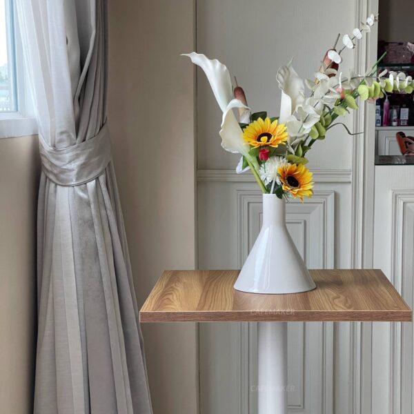 Oak top table with square white leg, beautifully adorned with a flower arrangement on top