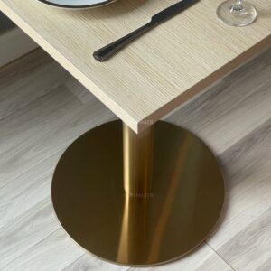 Base view of a parawood top table featuring golden leg