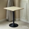 Isometric view of a table featuring a parawood top and round leg, showcasing its natural finish and design
