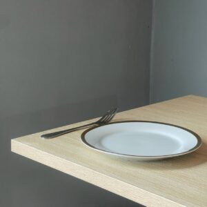 Close-up view of a parawood top table showcasing its smooth surface and sturdy metal leg
