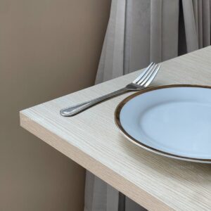 Close-up view of a parawood top table showcasing its smooth surface and square white leg