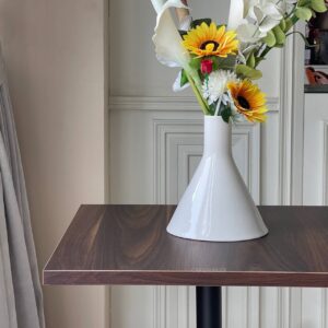 Walnut top table with round leg, beautifully decorated with a flower arrangement on top