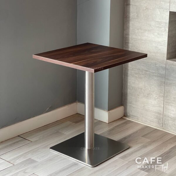 Isometric view of a walnut top table featuring sleek metal leg