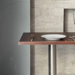 Top side view of a walnut top table featuring metal leg