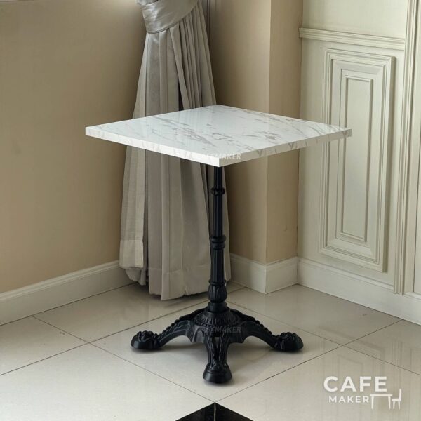Isometric view of a white marble table featuring ornate Roman legs, showcasing its elegant design