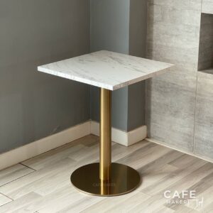 Isometric view of a white marble table featuring elegant golden leg, highlighting its sophisticated design.