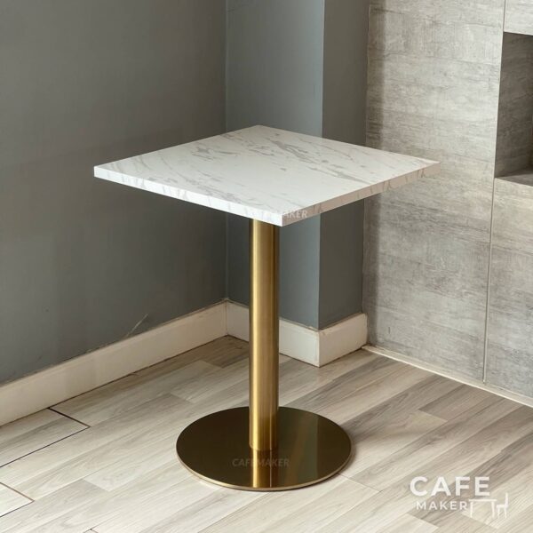 Isometric view of a white marble table featuring elegant golden leg, highlighting its sophisticated design.