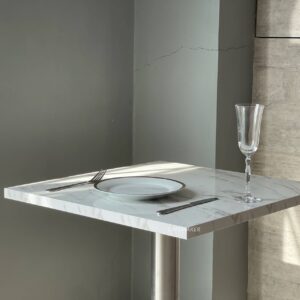 Close-Up of Square White Marble Table with Metal Leg