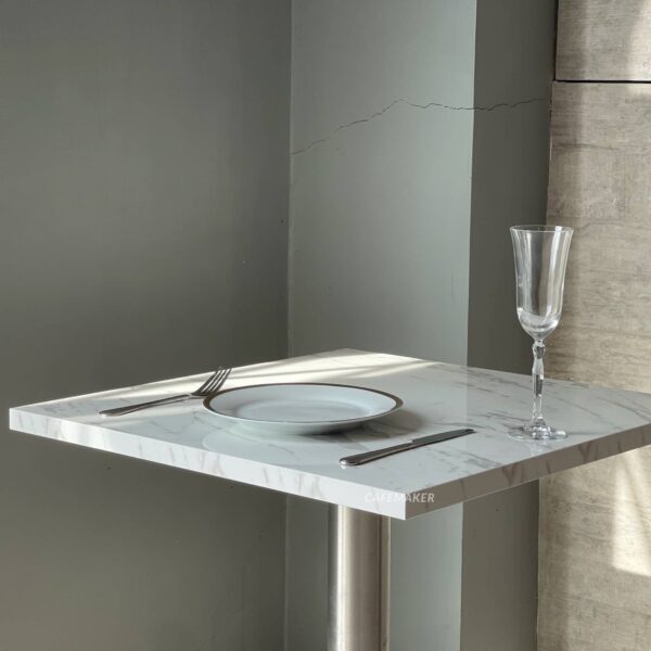 Close-Up of Square White Marble Table with Metal Leg