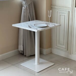 White marble top table with square legs, elegantly styled with a matching dining set