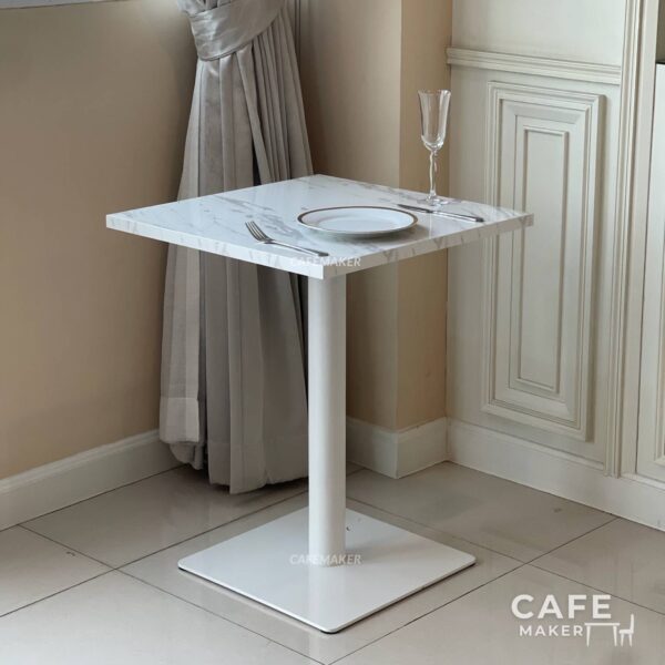 White marble top table with square legs, elegantly styled with a matching dining set