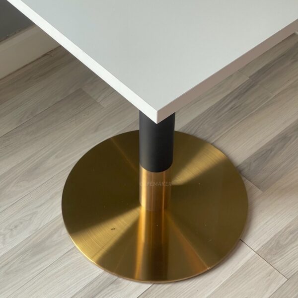 Square table with white top and black and gold leg base