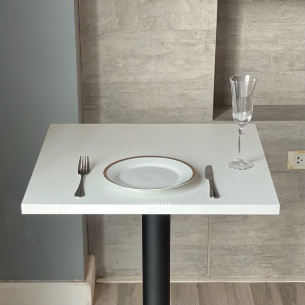 Top side view of a white top table with black-golden leg