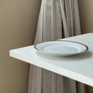 Close-up of a white top table with Roman leg
