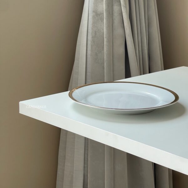 Close-up of a white top table with Roman leg