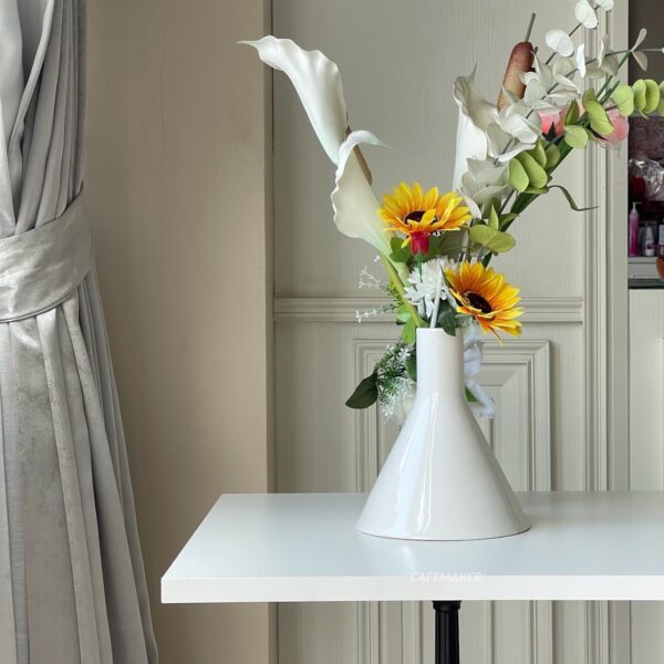 White top table with Roman leg decorated with flowers