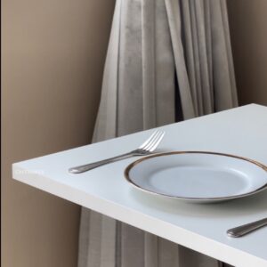 Close-up of white-top table with round leg