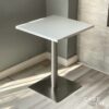 Isometric view of a white top table with square metal leg