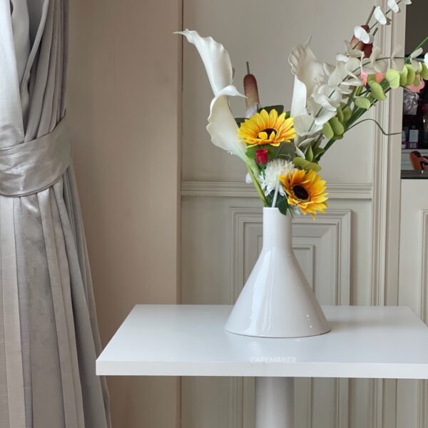 White top table with white leg decorated with flowers