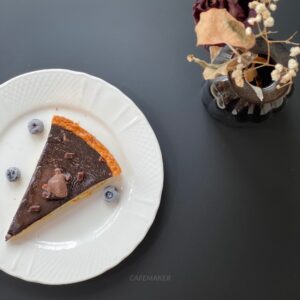 Black-top round table with round leg, arranged with an assortment of dessert