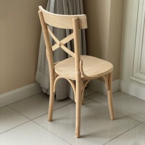 Isometric back view of a narrow natural parawood Windsor chair, highlighting its classic spindle backrest and natural finish