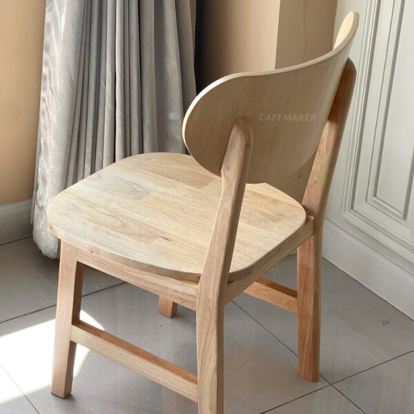 Isometric back view of a natural parawood café chair with a C-Curved backrest