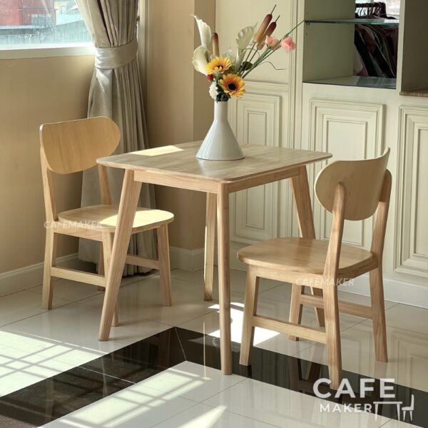 Natural parawood café chair with a C-curved backrest and seat in a café setting