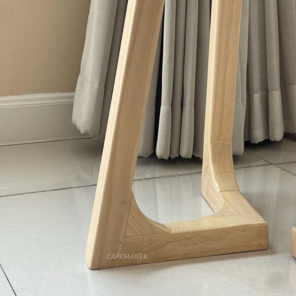 Close-up view of the base of a natural parawood farm table