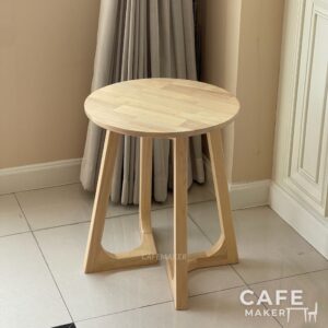 Isometric view of a natural parawood farm table, showcasing its sturdy construction and rustic design
