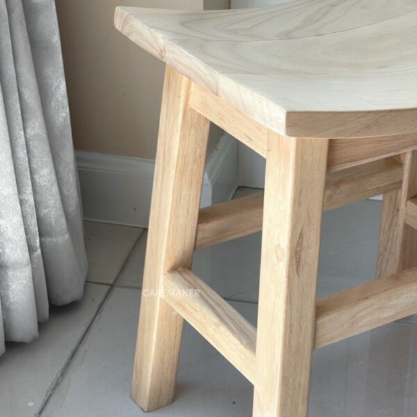 Close-up view of a natural parawood rectangle stool chair highlighting its texture and craftsmanship