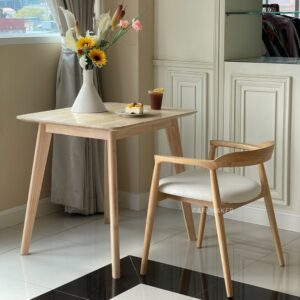 Natural parawood square end table decorated with a flower arrangement