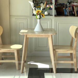 Side view of a natural parawood square end table
