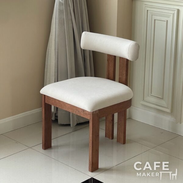 Isometric view of a parawood dining chair with a white cushioned seat