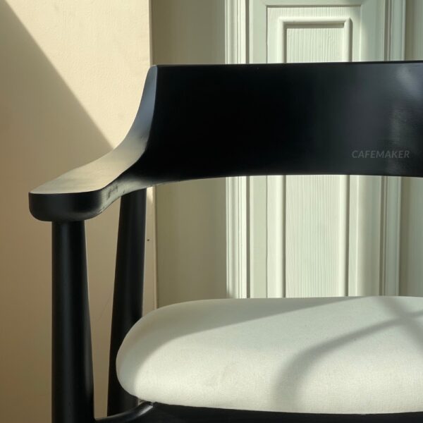Front view of a black parawood side chair featuring a thick backrest