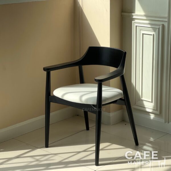Isometric view of a black parawood side chair with a thick backrest
